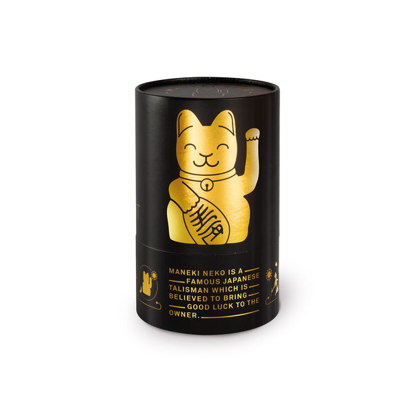 runde Zylinderförmige schwarze Verpackung mit glaenzender goldener Katze darauf